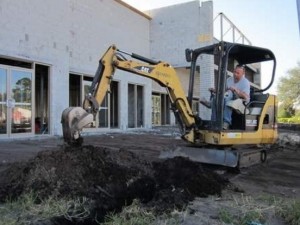 Cameron Cauthen of Paul's Electric digs a trench in front of the Dunlawton Commons retail complex nearing completion along Dunlawton Avenue in Port Orange, just east of Interstate 95. The complex will include Chicken Salad Chick and Tijuana Flats restaurants that are set to open this summer. NEWS-JOURNAL/BOB KOSLOW